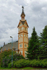 Church, built of wood, has nave flanked by two aisles and features delicate, slender bell tower. It is decorated with English Gothic style carvings. Kajaani, Finland