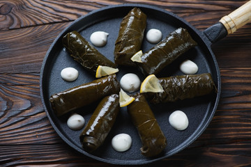 Wall Mural - Frying pan with dolma or stuffed grape leaves, studio shot