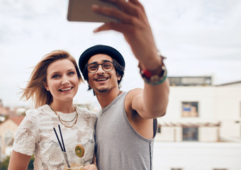 Wall Mural - Two young friends taking self portrait at party