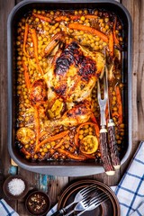 Wall Mural - Roasted whole chicken with chickpeas, carrots and lemons