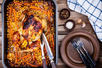 Wall Mural - Roasted whole chicken with chickpeas, carrots and lemons