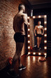 © honored - Young muscular man and mirror