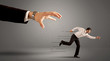 © ra2 studio - Businessman running away from a huge hand