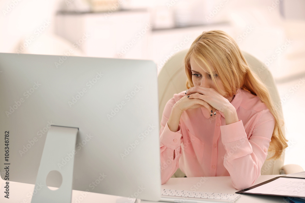 Tired woman at the computer in office
