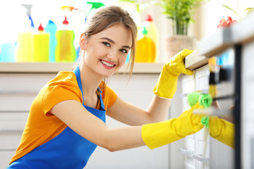 Poster - Cleaning concept. Woman washes an oven, close up