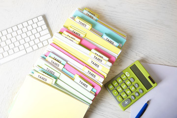 Poster - Folders with tax documents, keyboard and calculator on white wooden table