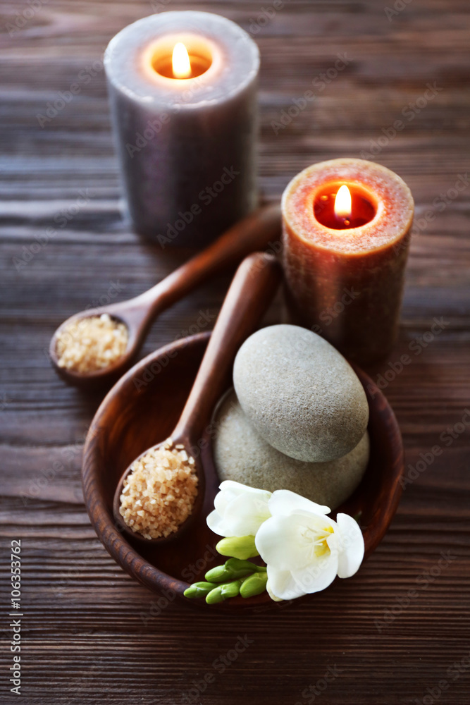 Spa composition with alight candles and beautiful flowers on wooden background