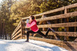 © e_serebryakova - Young sport woman doing exercises during winter training outside in cold snow weather by evening.