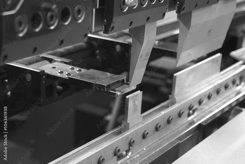 Bending press that works a piece of sheet metal. - obrazy, fototapety, plakaty 