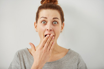 Wall Mural - Surprise astonished woman. Closeup portrait woman looking surprised in full disbelief wide open mouth isolated grey wall background. Positive human emotion facial expression body language. Funny girl