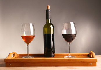 wine bottle and wine glass on a glass table