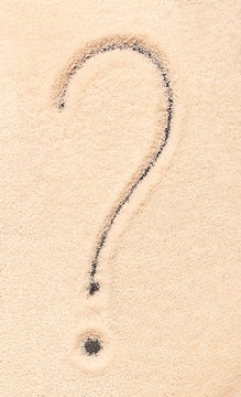 Question mark symbol written on sand
