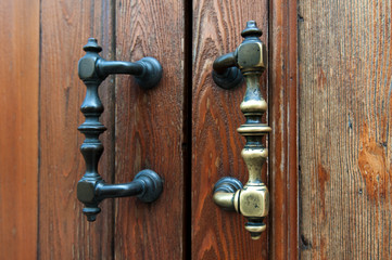 Old doorknobs, doorknockers and handles on ancient doors