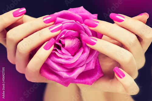 Fényképezés Elegant female hands with pink manicure on the nails