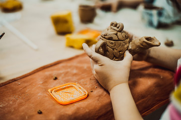 Wall Mural - Child sculpts from clay jug