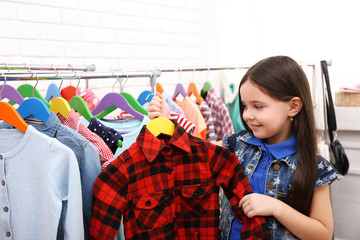 Little girl trying on a new shirt