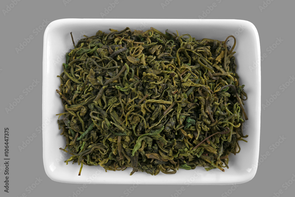 Kuding tea leaves in bowl, isolated on white