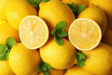 Sticker - Pile of wet lemons with halves and green leaves closeup