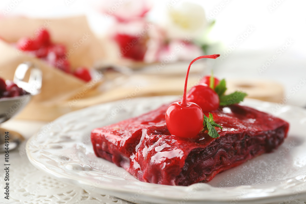 Cherry strudel with mint on plate
