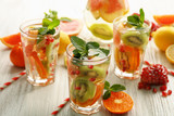 Fototapeta Kuchnia - Refreshing cocktails with ice, mint, pomegranate seeds and slices of fruits