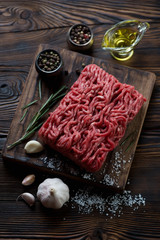 Wall Mural - Raw ground beef meat in a rustic wooden setting, studio shot