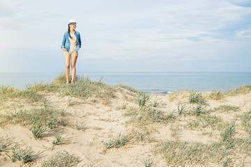 Wall Mural - Woman walking away on the idylic beach.