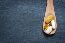 Healthy Supplements On Wooden Spoon