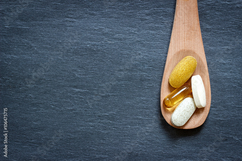 Fotografia Healthy supplements on wooden spoon
