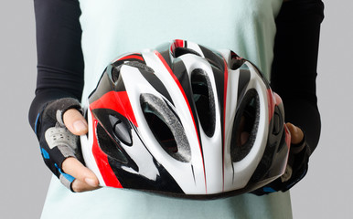 Woman holding bicycle helmet ready to cycling