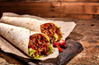 Pair of Chili Stuffed Tex Mex Wraps on Wood Table