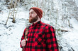 © Drobot Dean - Serious bearded man with backpack in winter mountain forest