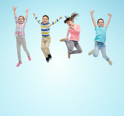 Wall Mural - happy little children jumping in air over blue