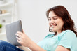 © Syda Productions - happy young plus size woman with tablet pc at home