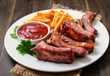 Pork ribs and tomato sauce on white plate