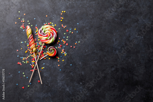 Plakat Colorful candies lollipops over stone