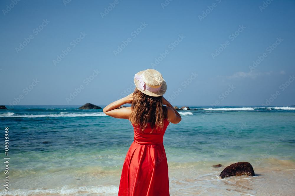 Elegant Beautiful Woman in Red Dress and straw hat on the Beach. Stock ...