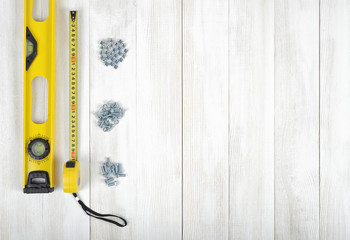 Wall Mural - Layout of tools for constructing and manufacturing including nuts, screws, nail, tape measure, level