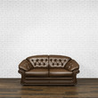 Dark brown leather sofa standing on wooden parquet floor with empty white painted brick wall background. 3d rendering.