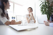 © Monet - Women have a discussion in a bright office
