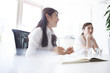 © Monet - Young women have a discussion in a stylish office