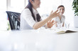 © Monet - Young women have a discussion in a stylish office