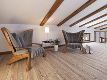 The Attic Floor With A Seating Area With Designer Chairs And A L
