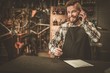 © Nejron Photo - Stylish bicycle mechanic takes order by phone in his workshop.