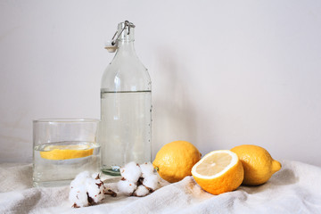 Wall Mural - Tasty cool beverage with lemon on white cotton fabric