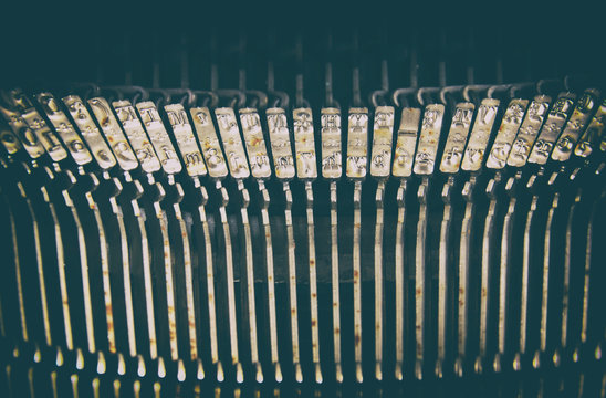 close up image of metallic typewriter keys. vintage filtered. selective focus
