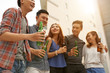 © DragonImages - Group of Vietnamese young people drinking beer and chatting outdoors