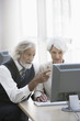 © Klaus Tiedge/Blend Images - Senior Caucasian business people working together in office