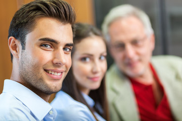 Portrait of a businessman in front of his colleagues