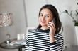 © Dmytro Mykhalets - Fashionable young woman with beautiful make up talking on her cell phone amd smile on camera.
