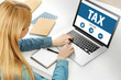 Online Tax payment concept. Woman working with laptop in the office